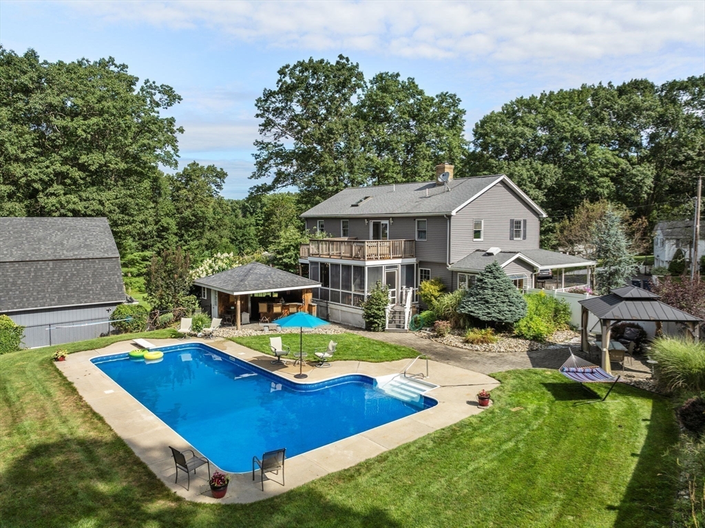 a view of a house with swimming pool and sitting area