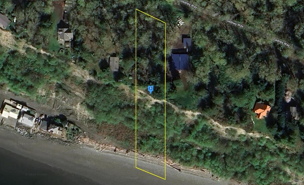 an aerial view of a house with a yard and street view