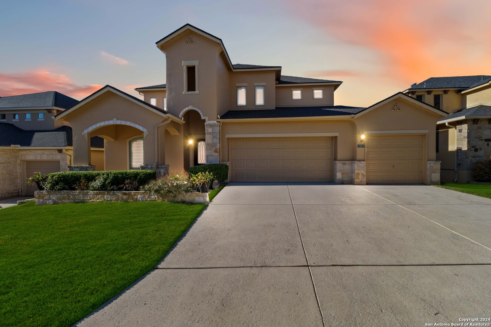 a front view of a house with a yard and garage