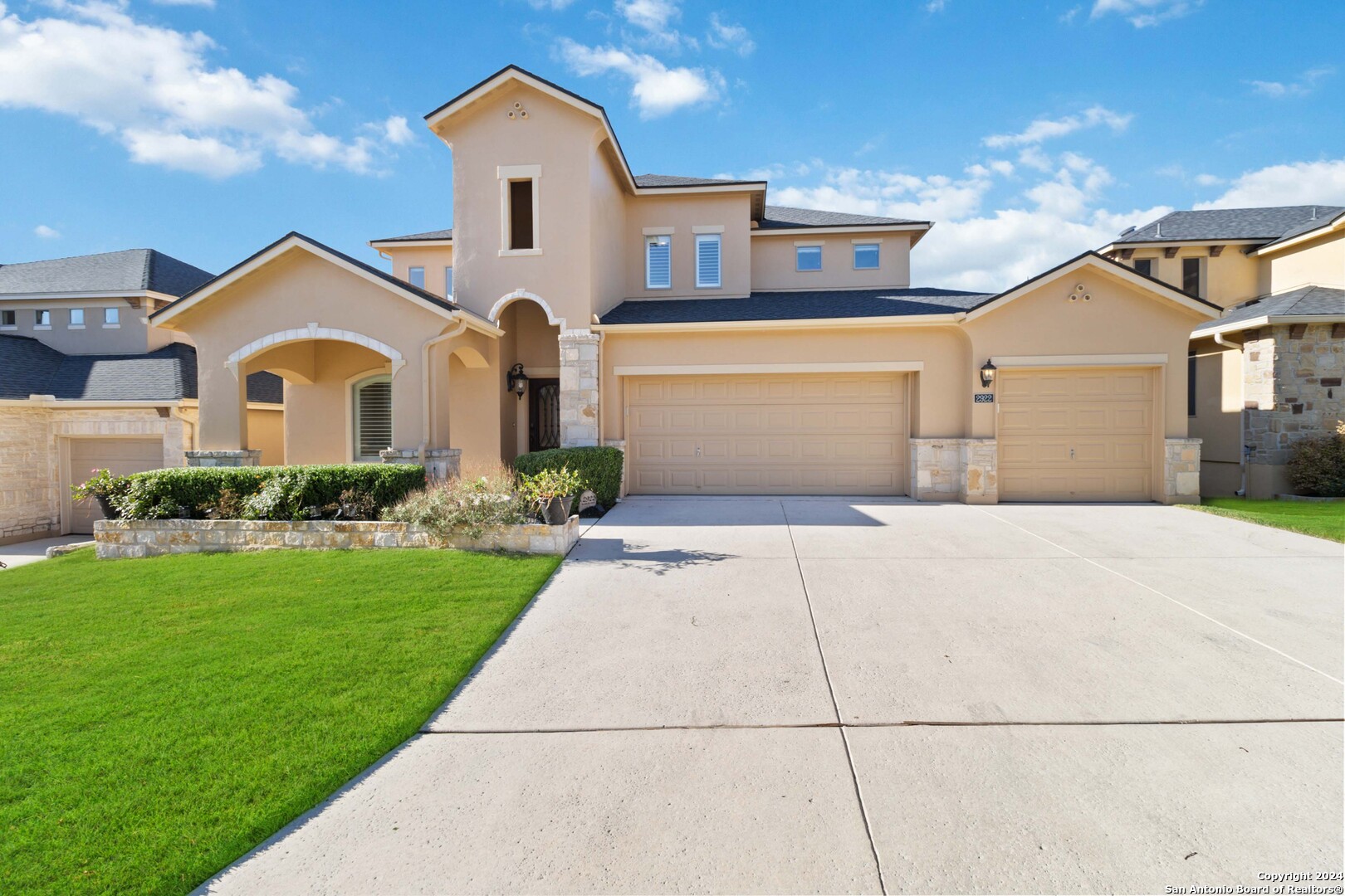 a front view of a house with a yard and garage