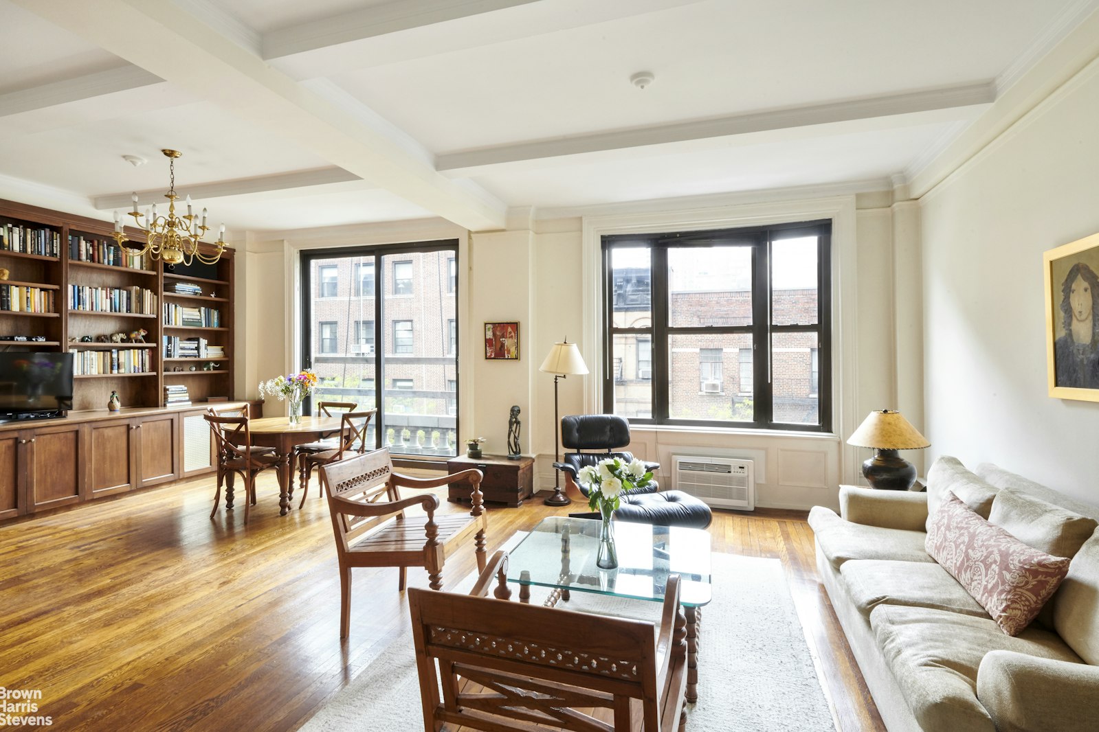 a living room with furniture a dining table and a large window