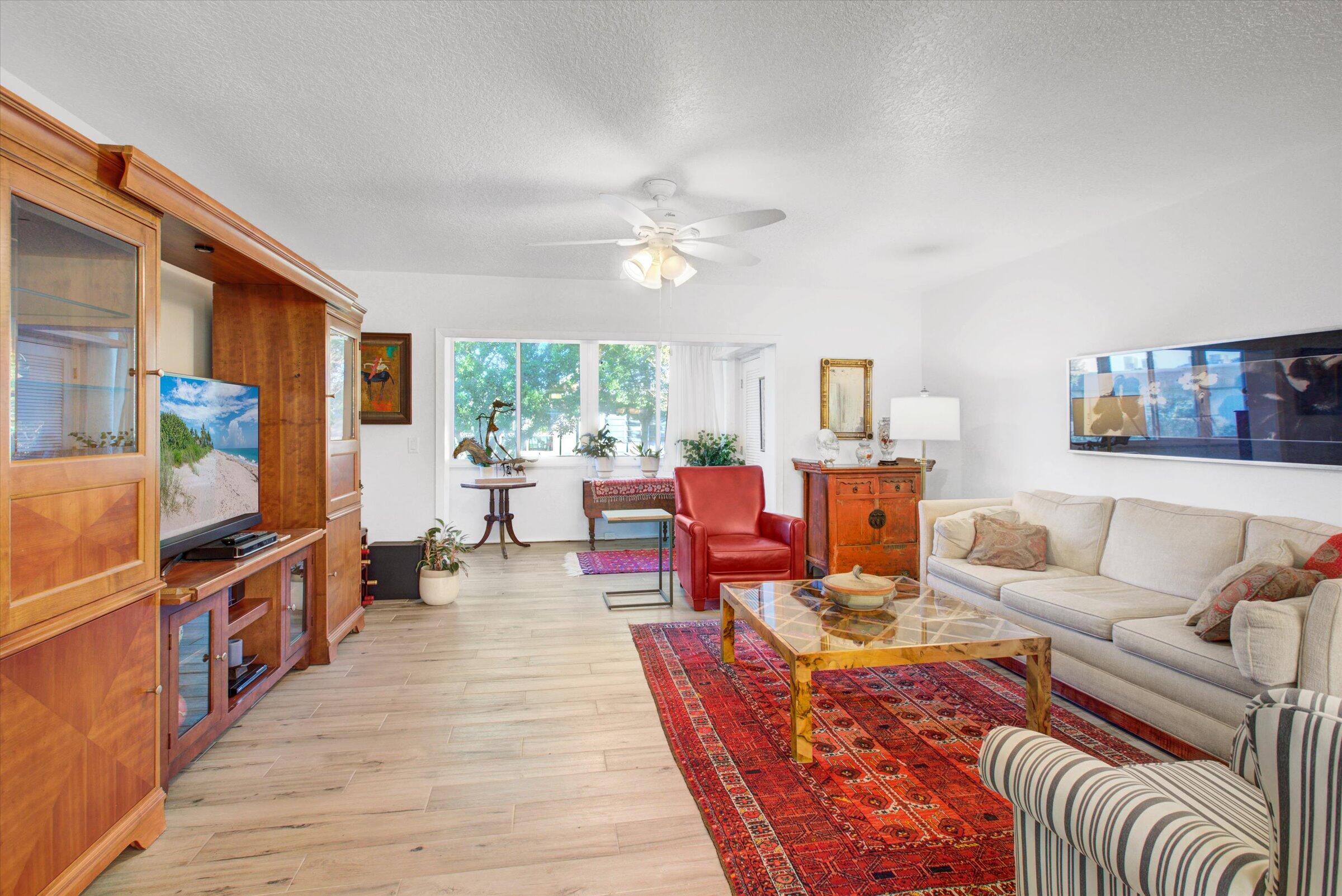 a living room with furniture fireplace and a large window