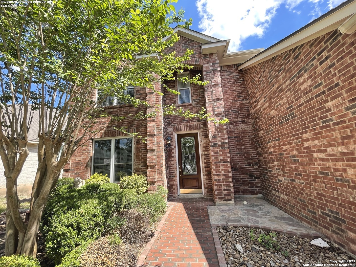 a view of a brick house with a large windows