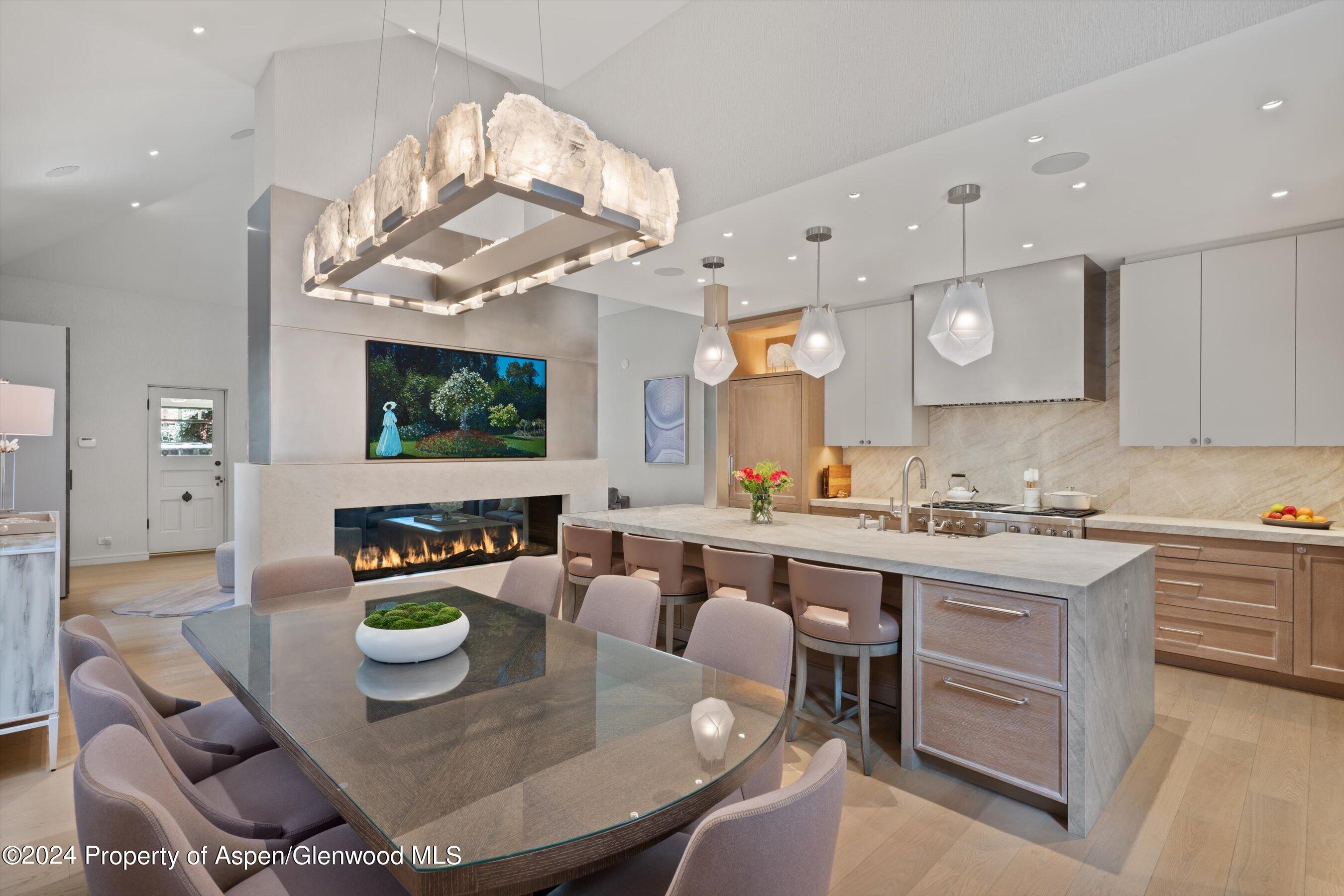 a open dining room with kitchen island furniture a chandelier and kitchen view