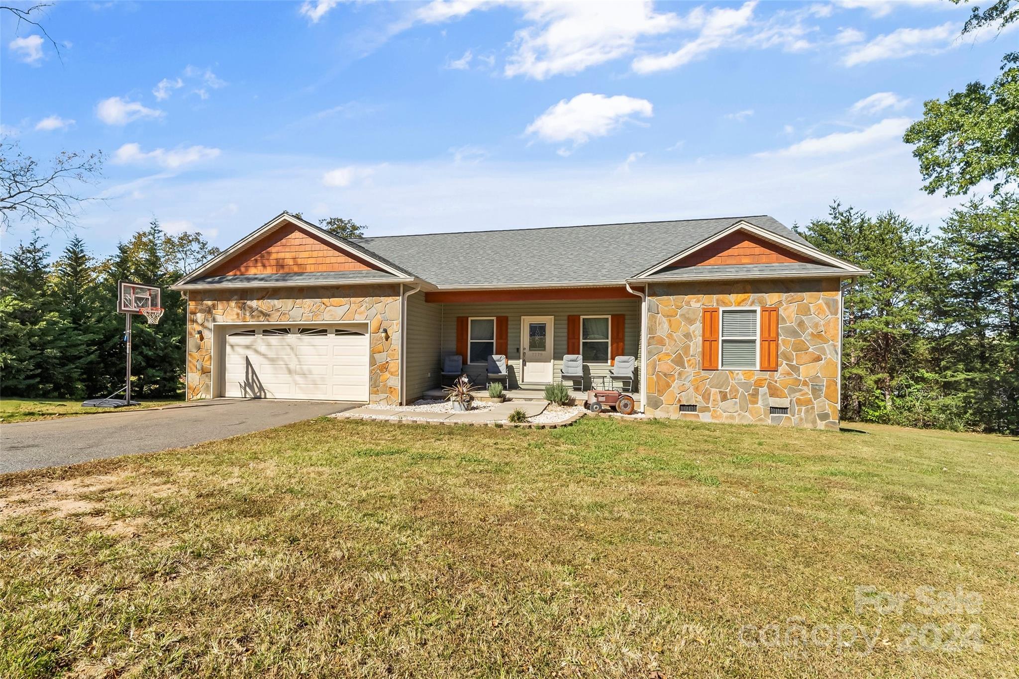 a front view of a house with yard porch and outdoor seating