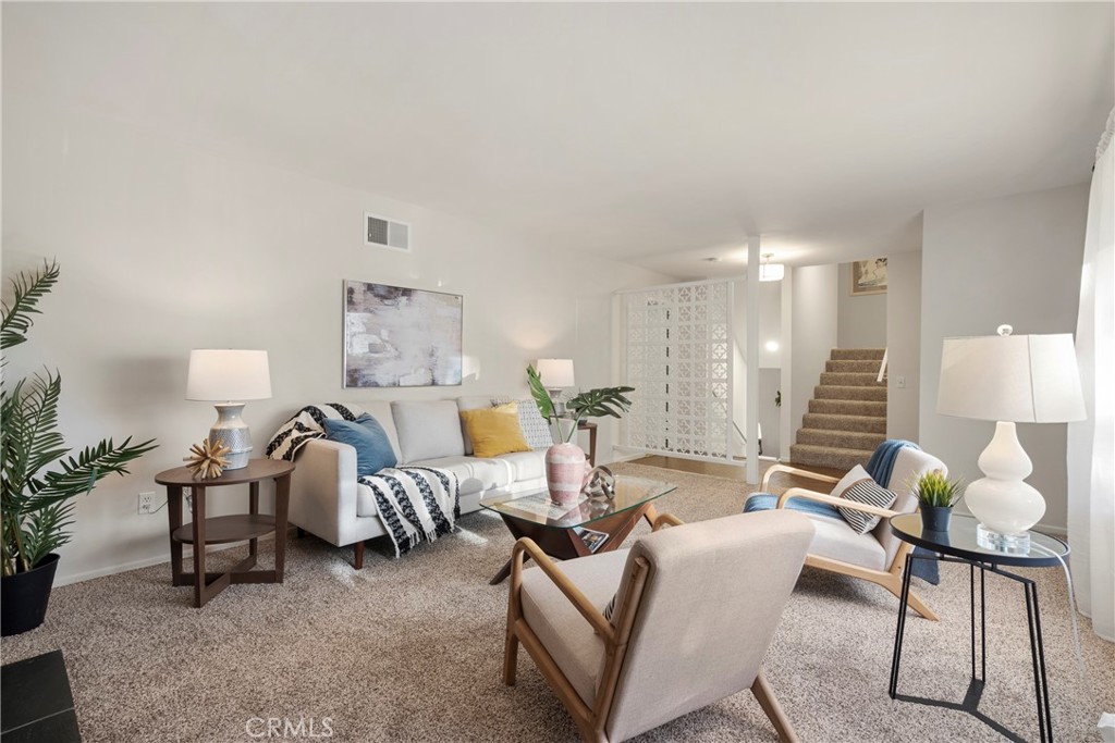 a living room with furniture and a lamp