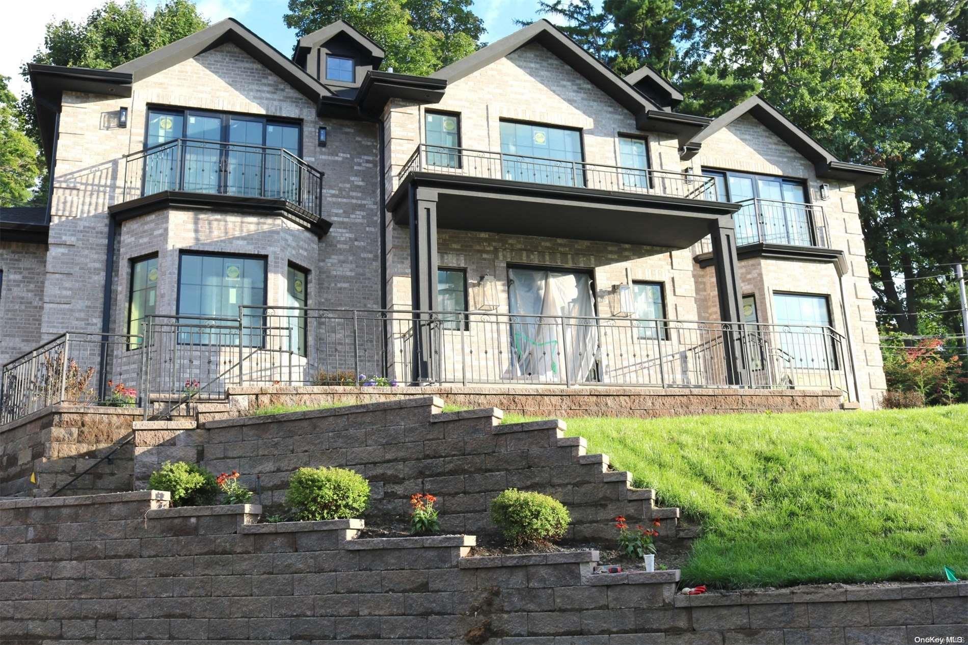 a front view of a house with a garden