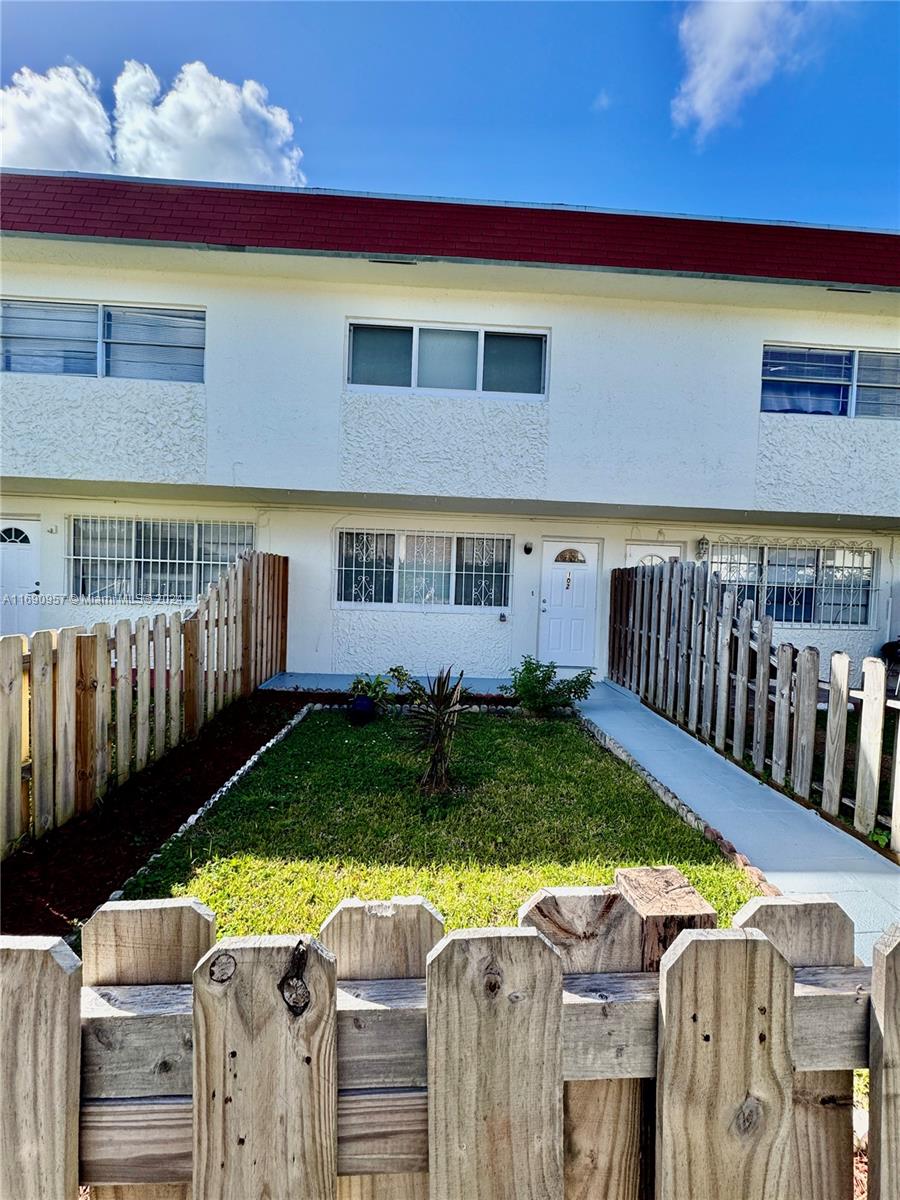 a view of an house with backyard space and balcony