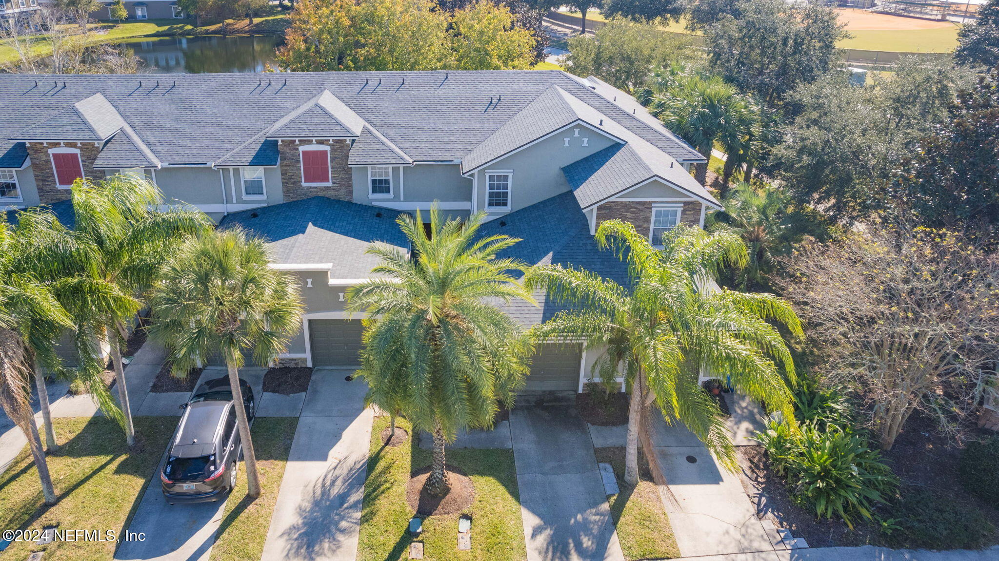 a aerial view of a house with wooden floor and outdoor seating