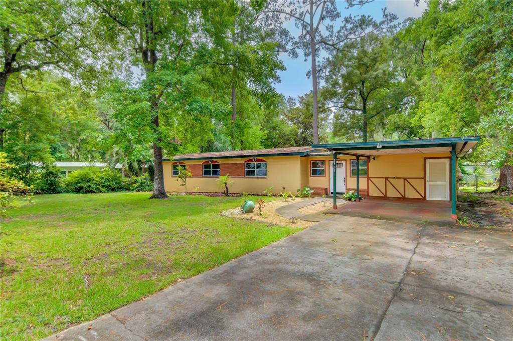 a front view of house with yard and trees