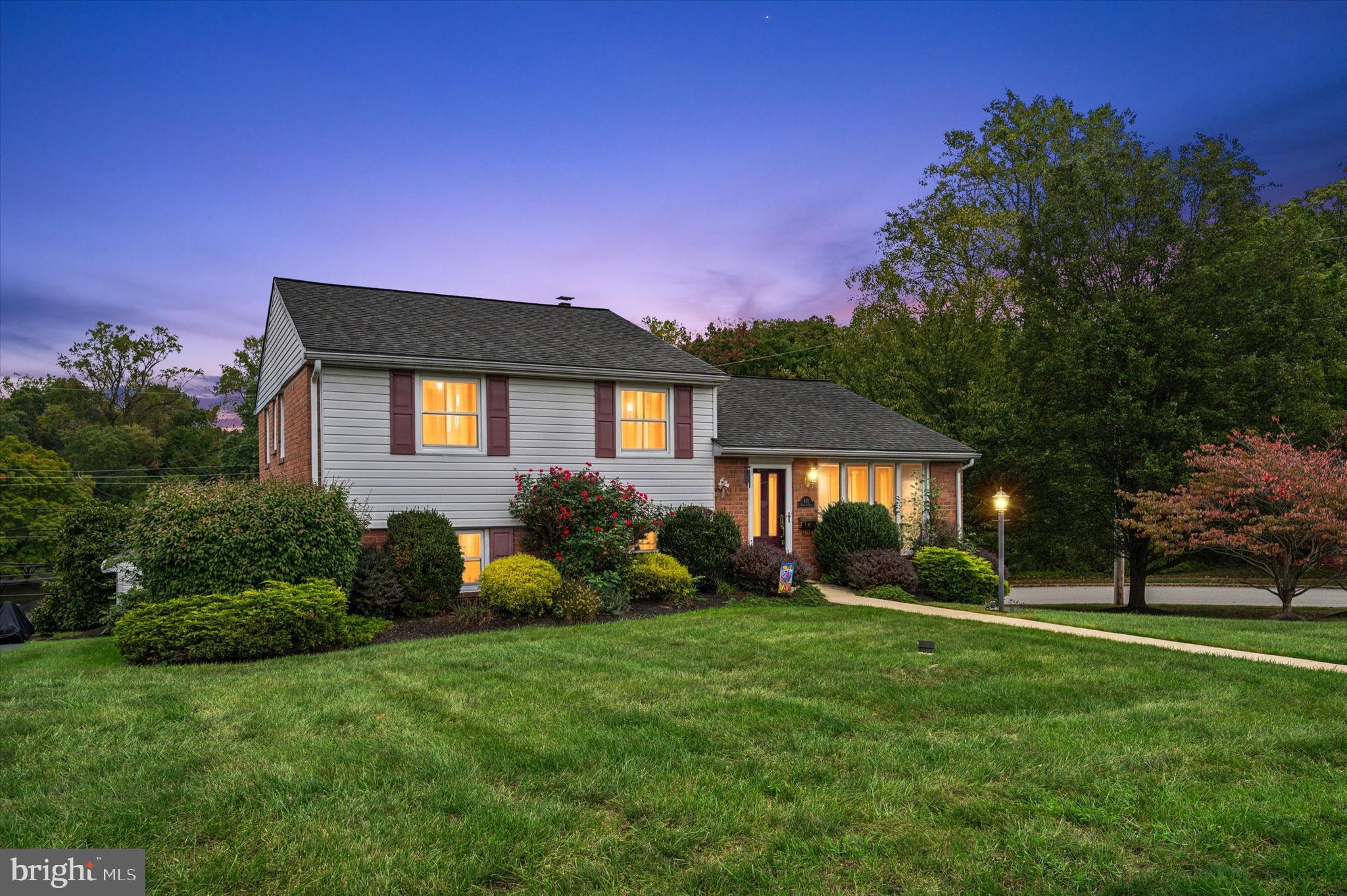 a front view of house with yard and green space