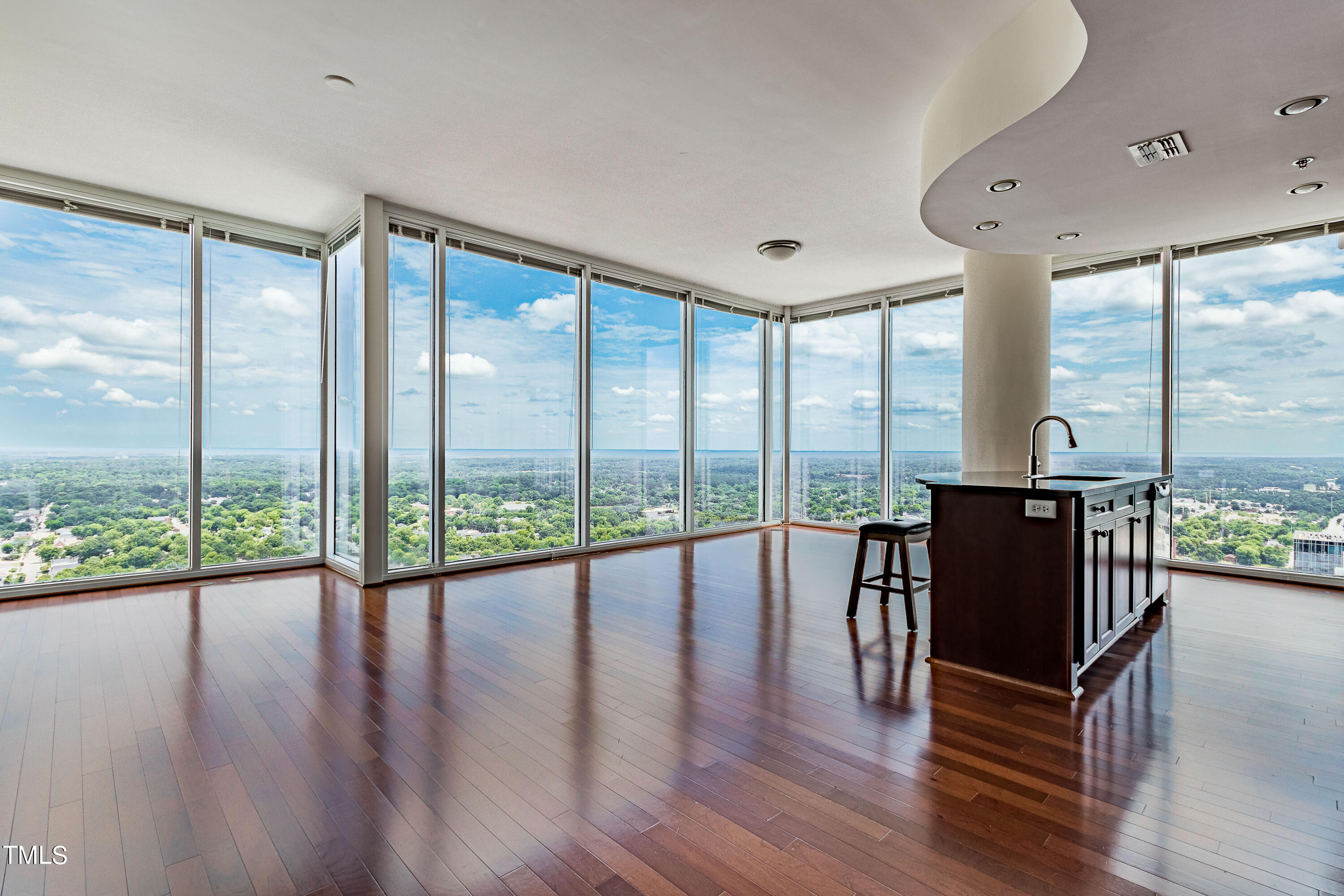 a view of a room with wooden floor and windows