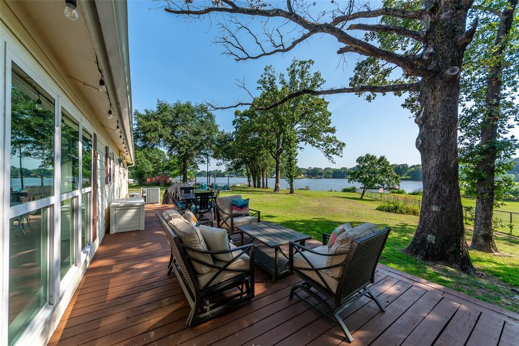 a view of a chair and table on the wooden deck