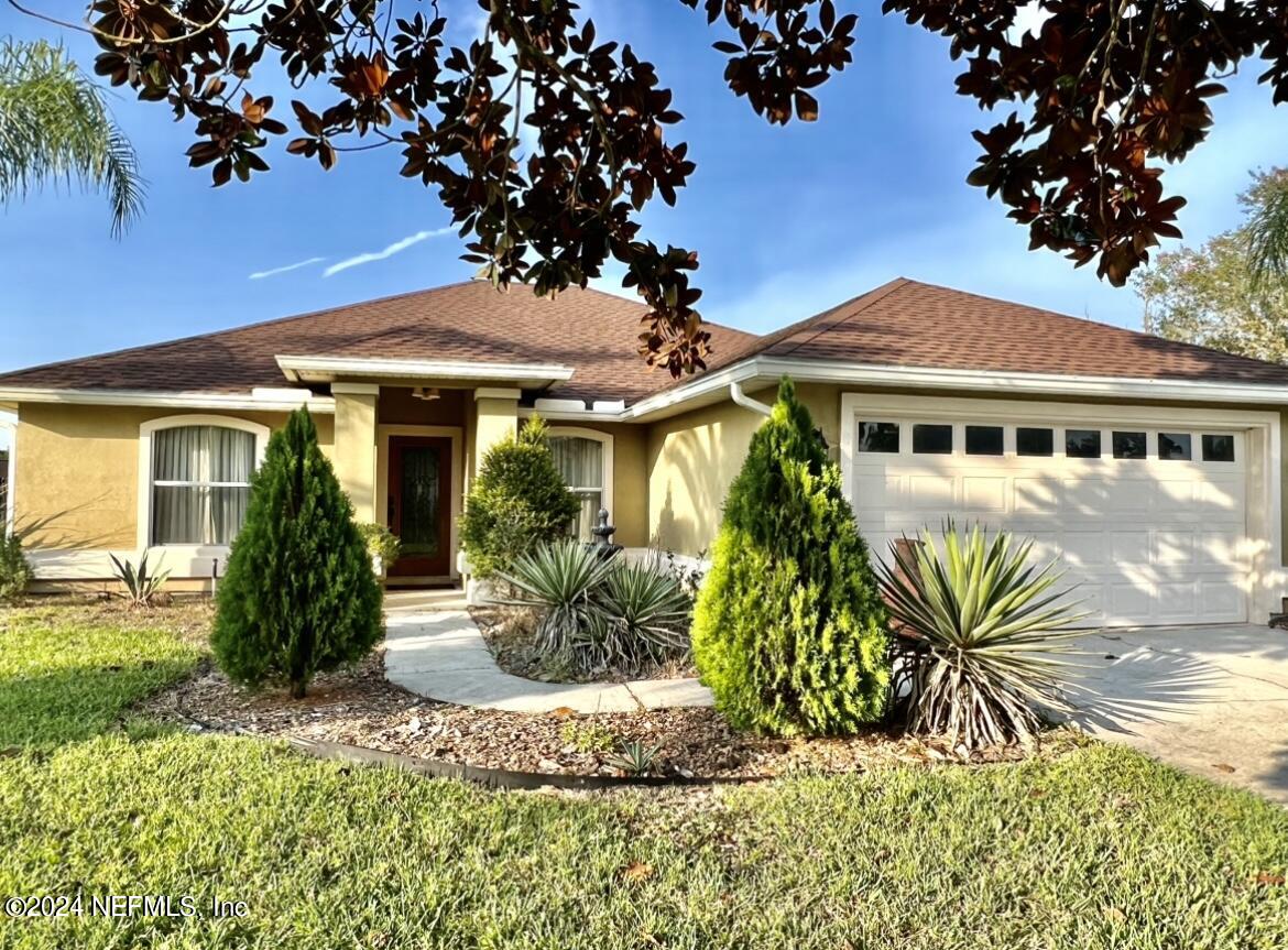 a front view of a house with garden