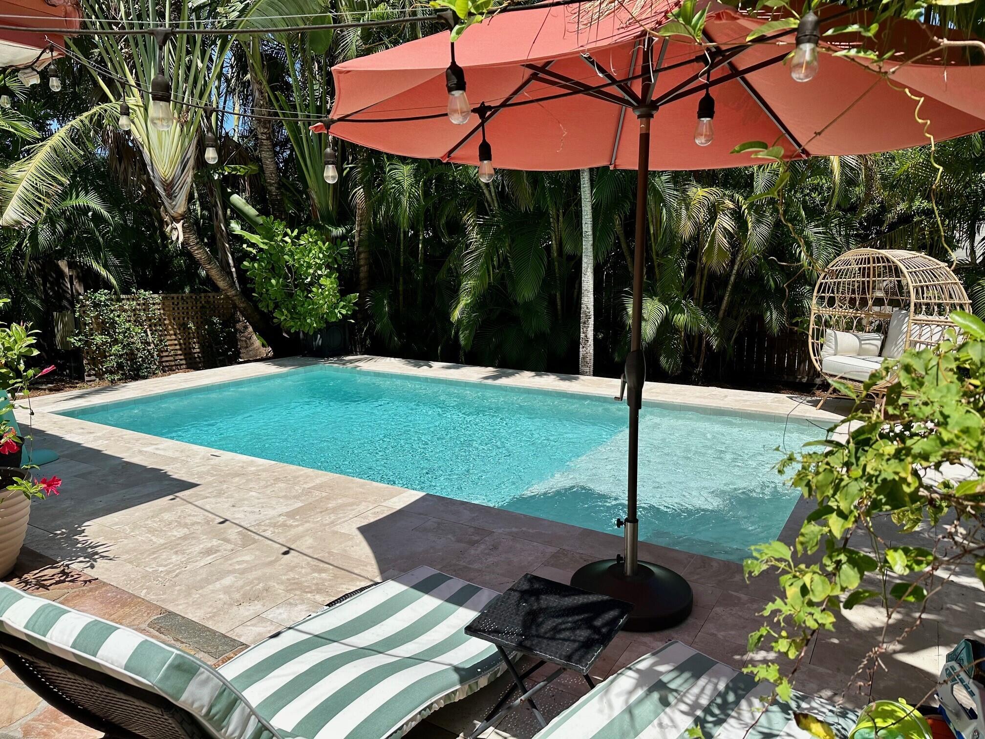 a view of a backyard with sitting area