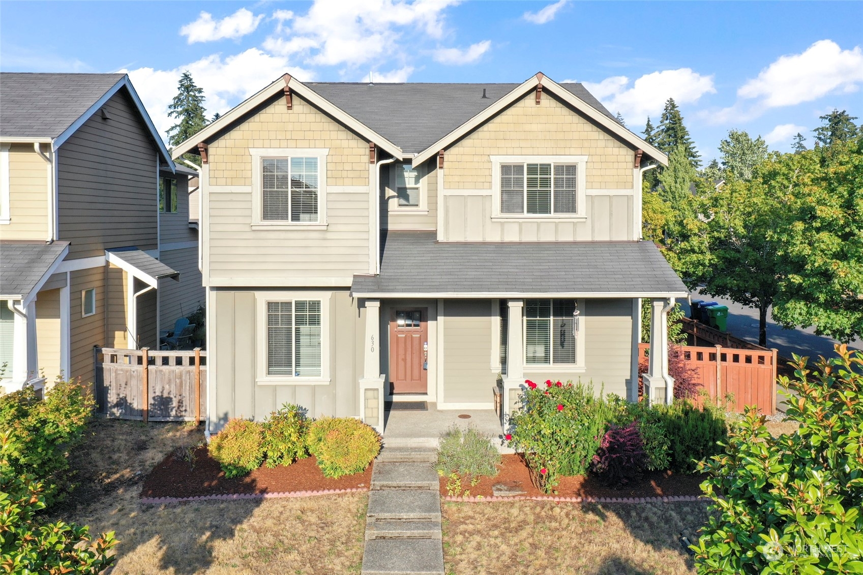 a front view of a house with a yard and outdoor seating