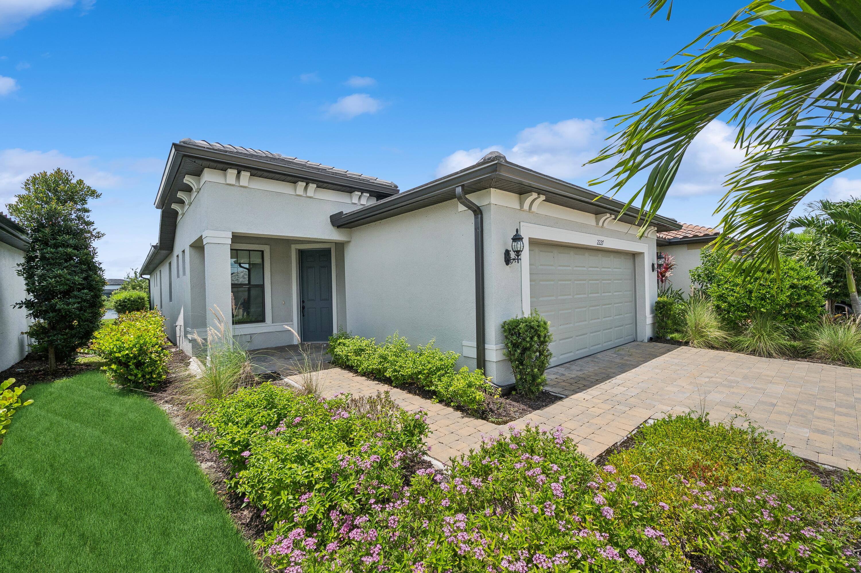 a front view of house with yard and trees around