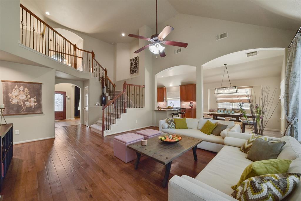 living room seamlessly flows into dining area and kitchen with fresh paint and new hardwood floors