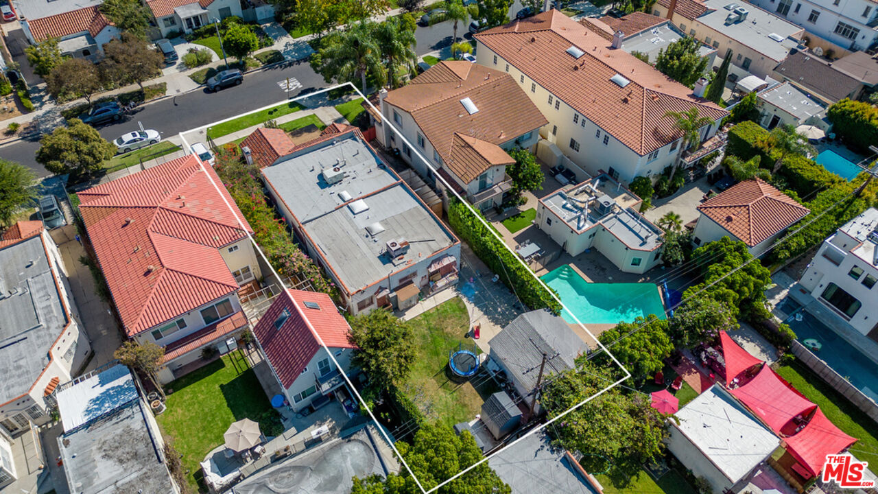 an aerial view of a houses with yard