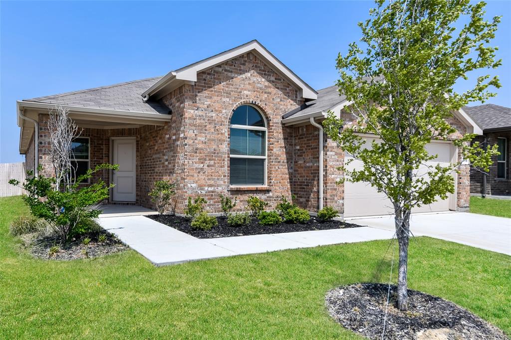 a front view of a house with a yard