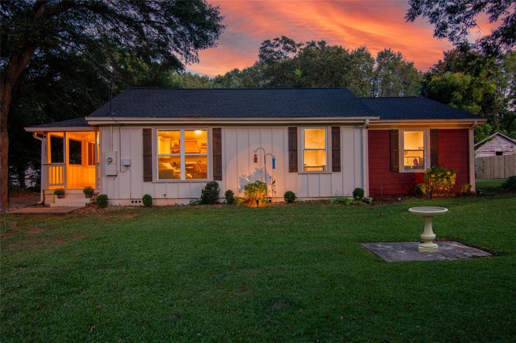 a front view of house with yard and outdoor seating