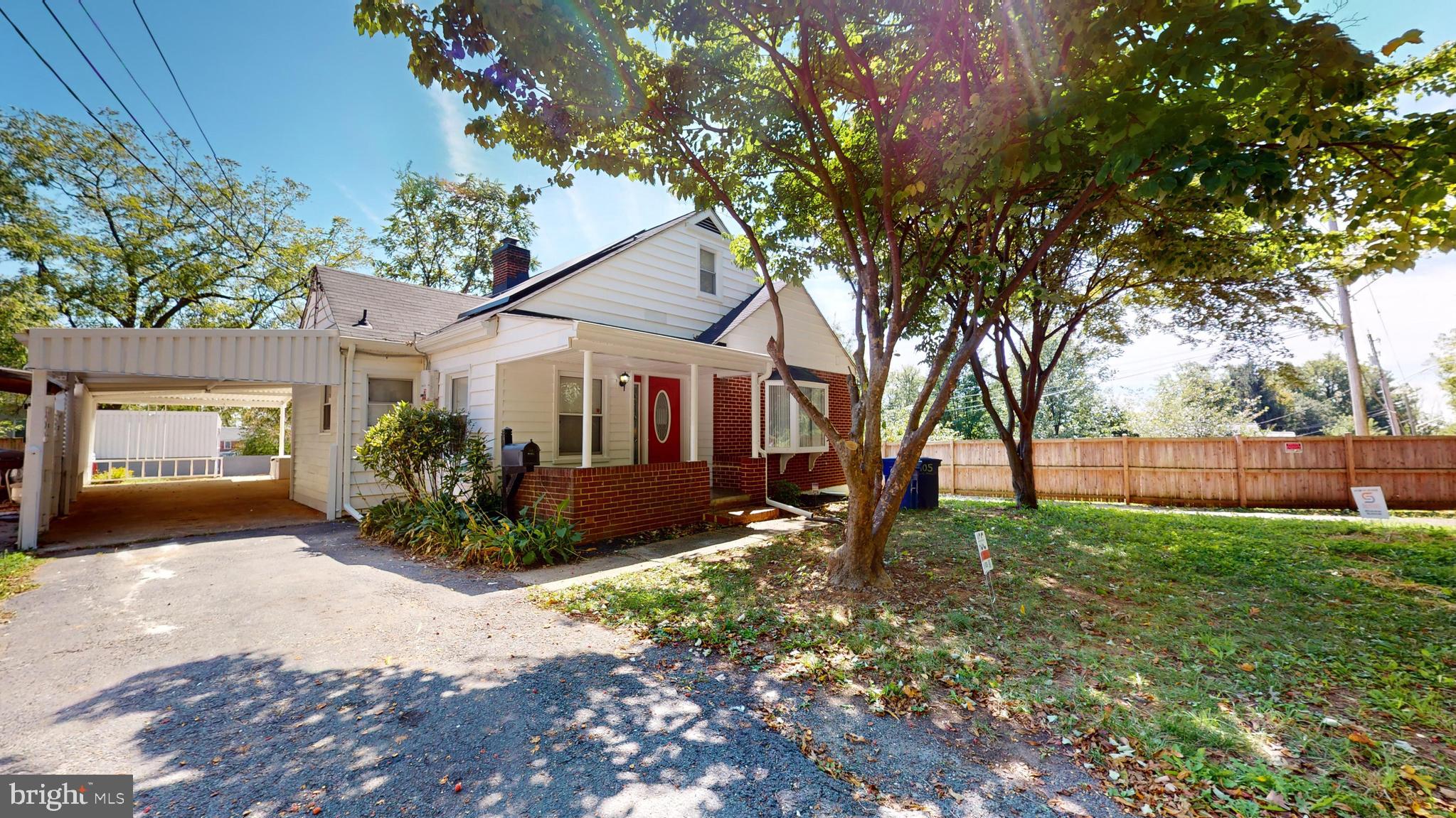 a front view of a house with a yard and potted plants