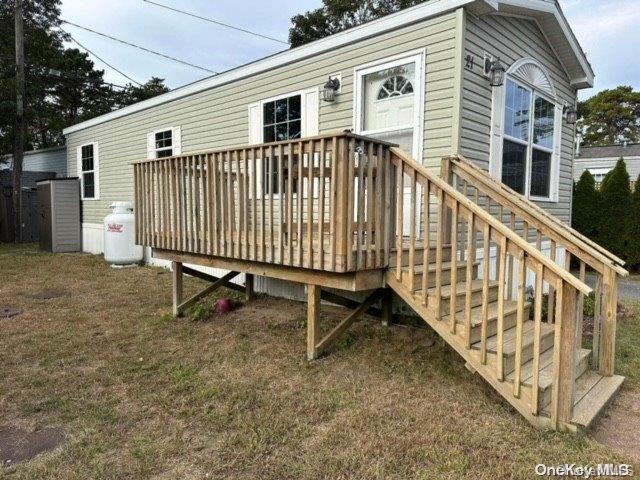 a view of a house with a wooden deck