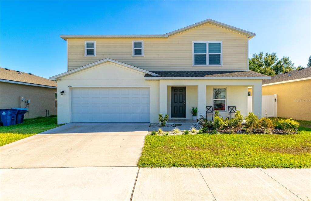 a front view of a house with a yard and garage