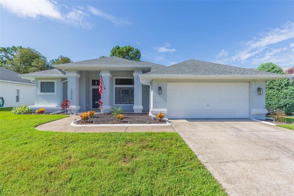 a front view of a house with patio and yard