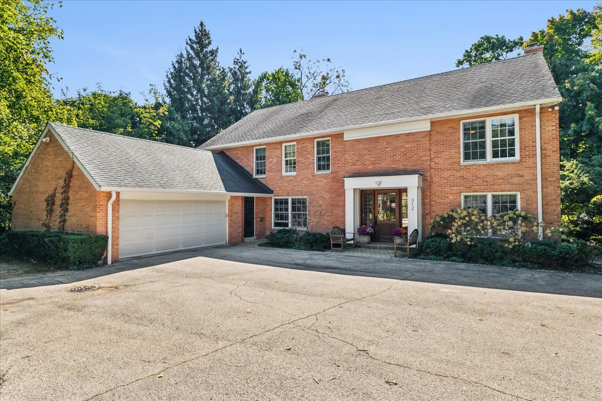 a front view of a house with a yard and a garage