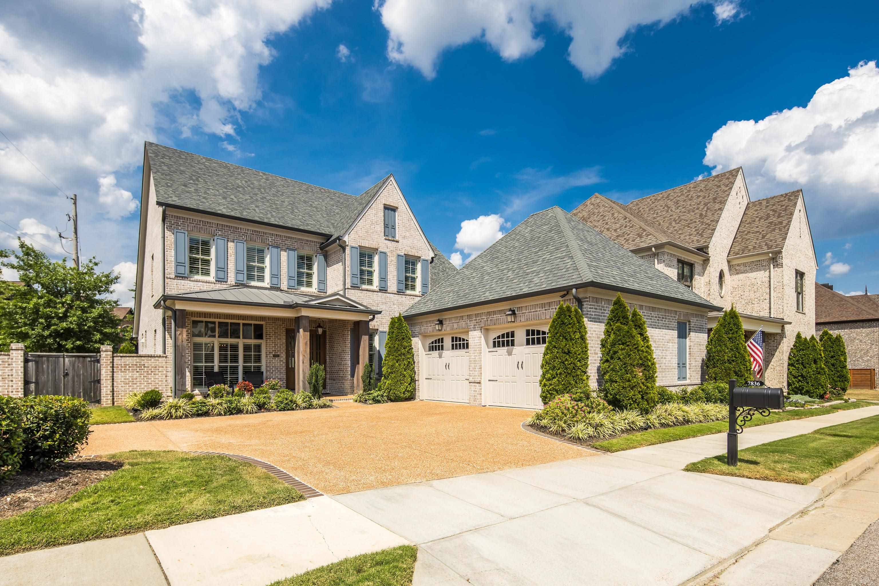 a front view of a house with a garden