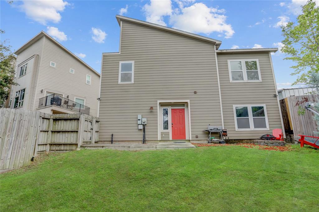 Welcome to 5309 Avenue J! Here you can see the front door, grass lawn, and the firepit off to the right.