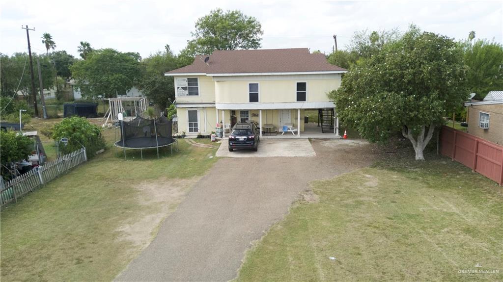 a view of a house with backyard and sitting area