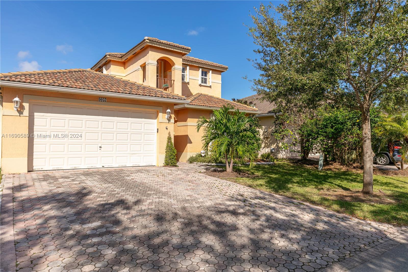 a front view of a house with a yard and garage