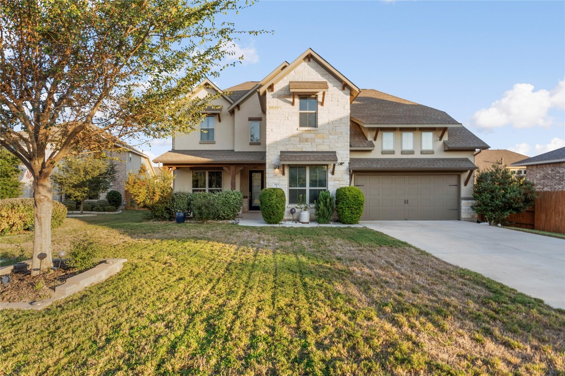 a front view of a house with a yard and garage