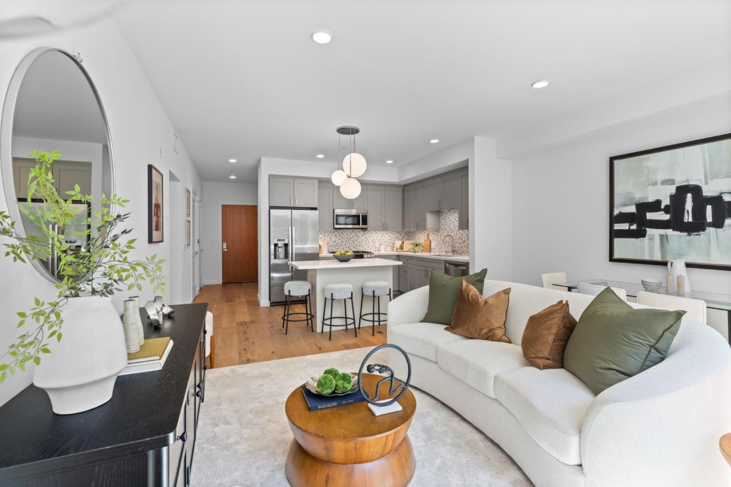 a living room with furniture kitchen and a chandelier