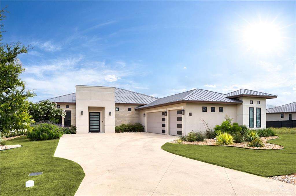 View of front facade with a garage and a front lawn