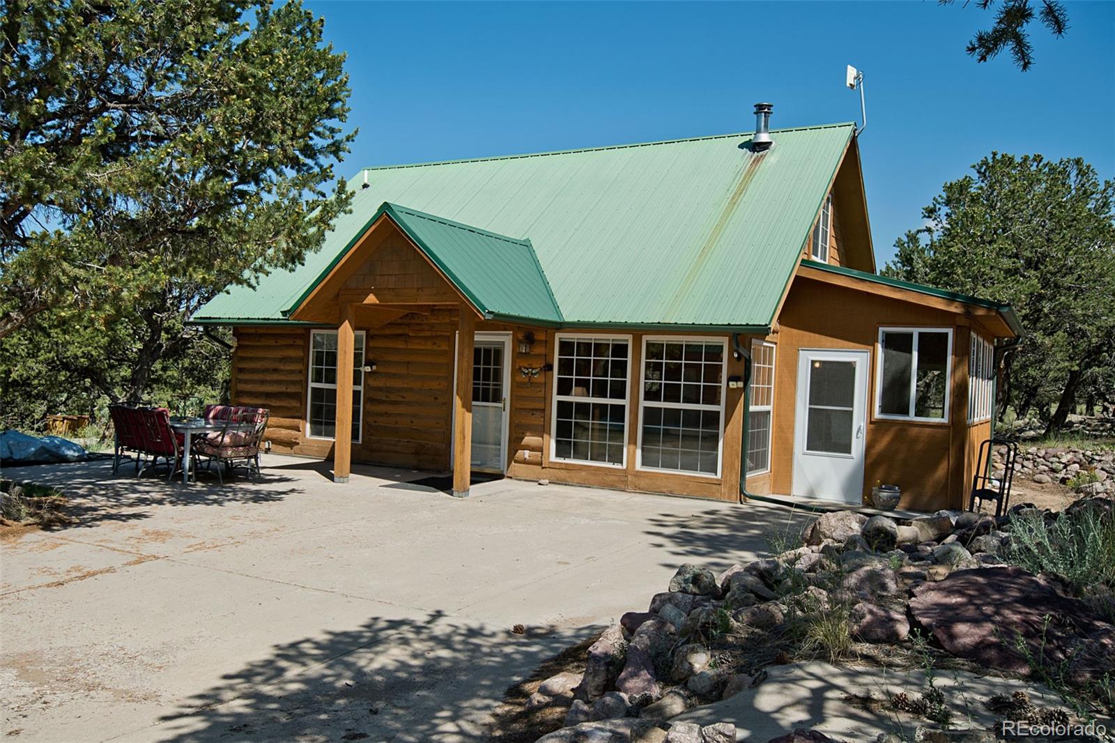 a view of a house with a patio and a yard