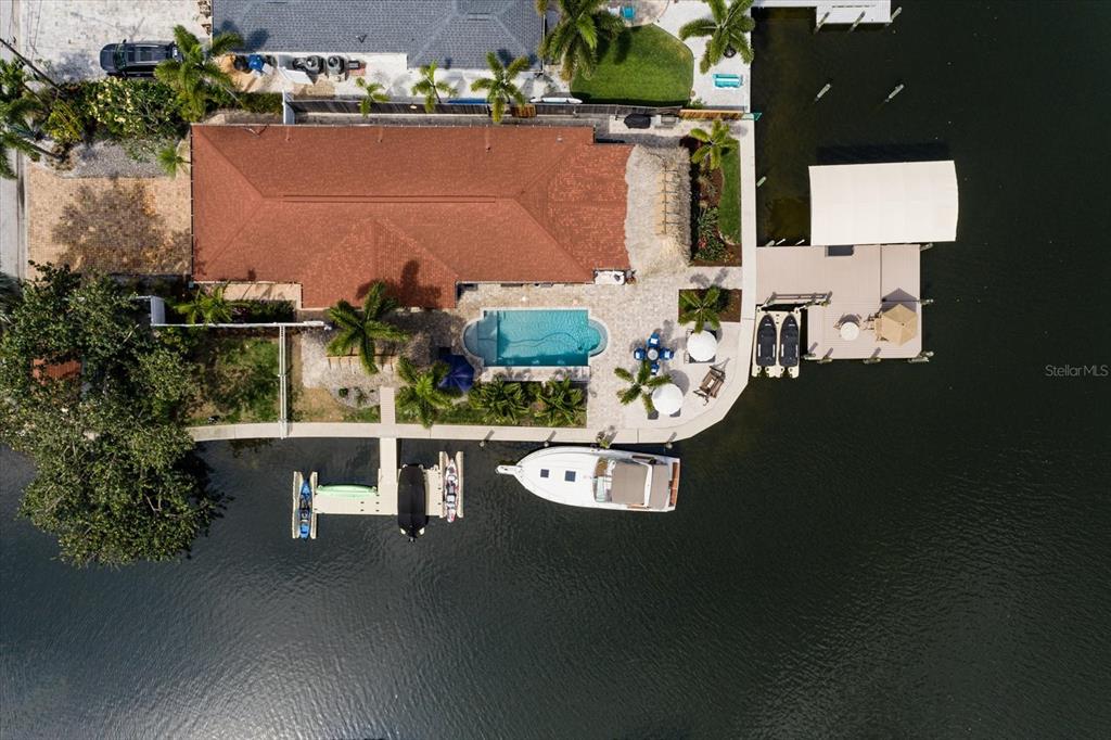 an aerial view of a house with outdoor space pool seating area and fire pit