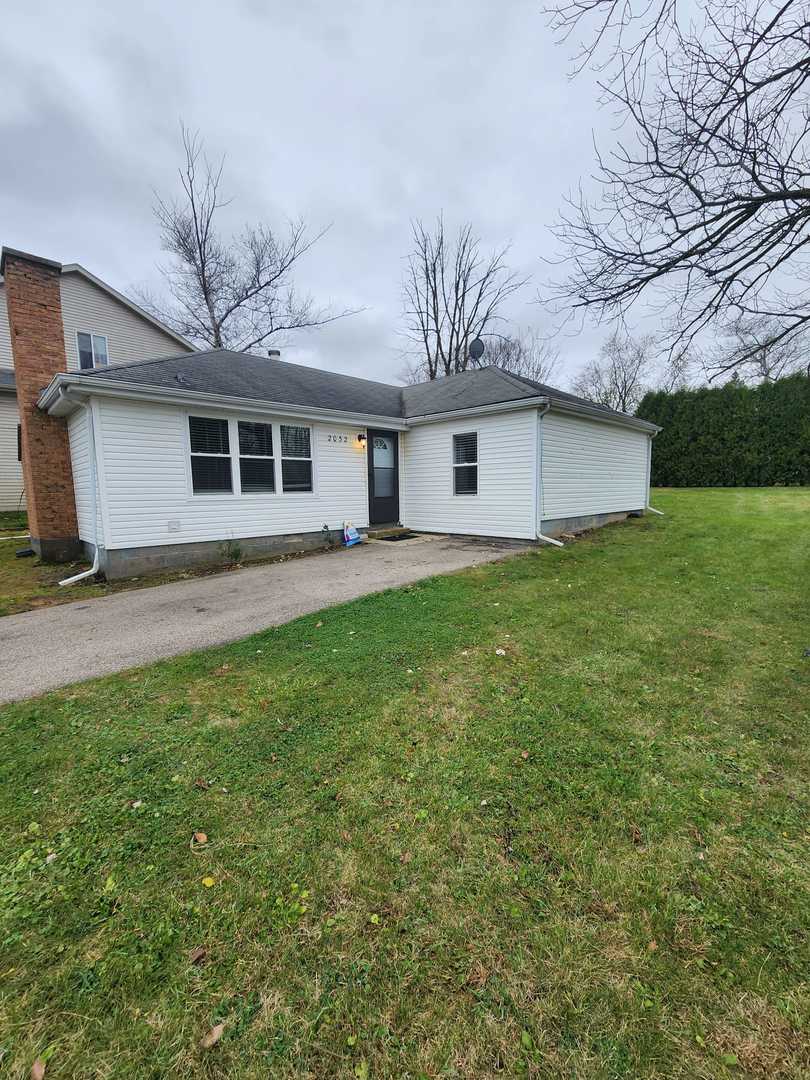 a front view of house with yard and trees