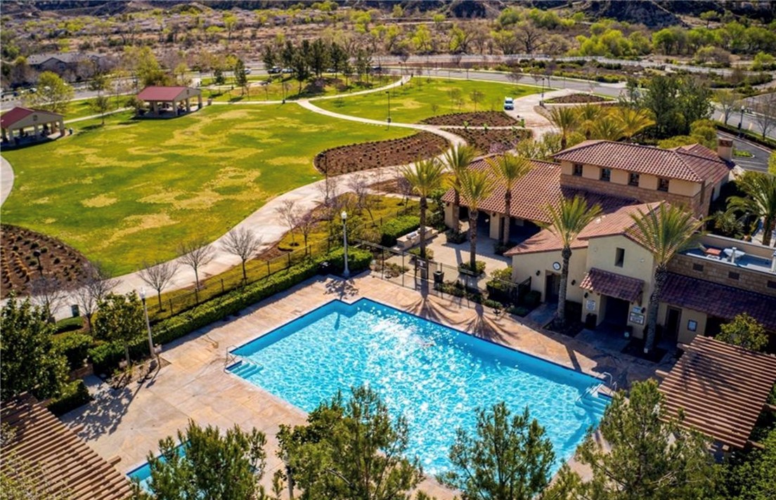 an aerial view of residential houses with outdoor space and swimming pool