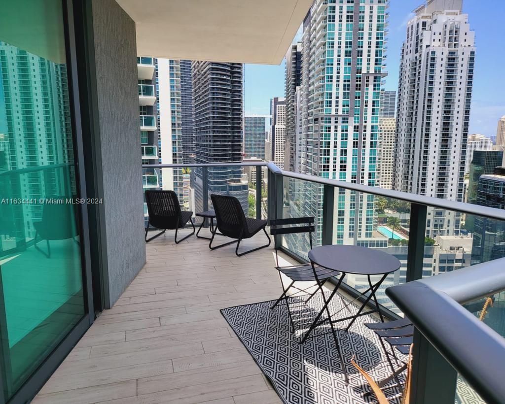 a balcony with table and chairs