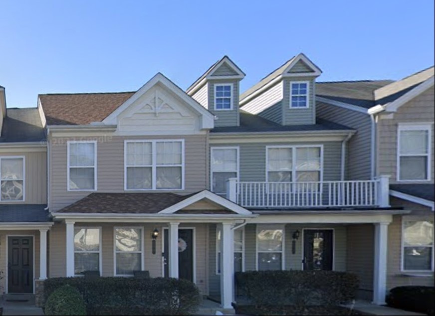 a front view of a brick house with many windows