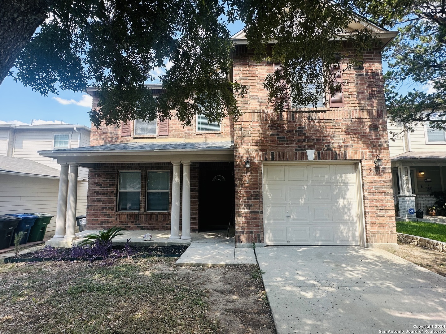 a view of a house with a yard and garage