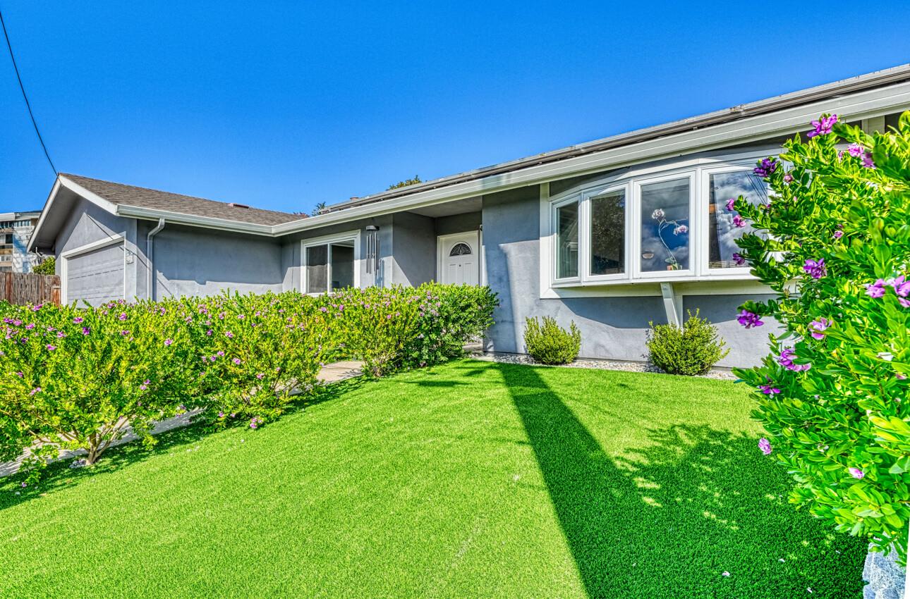 a front view of a house with a yard