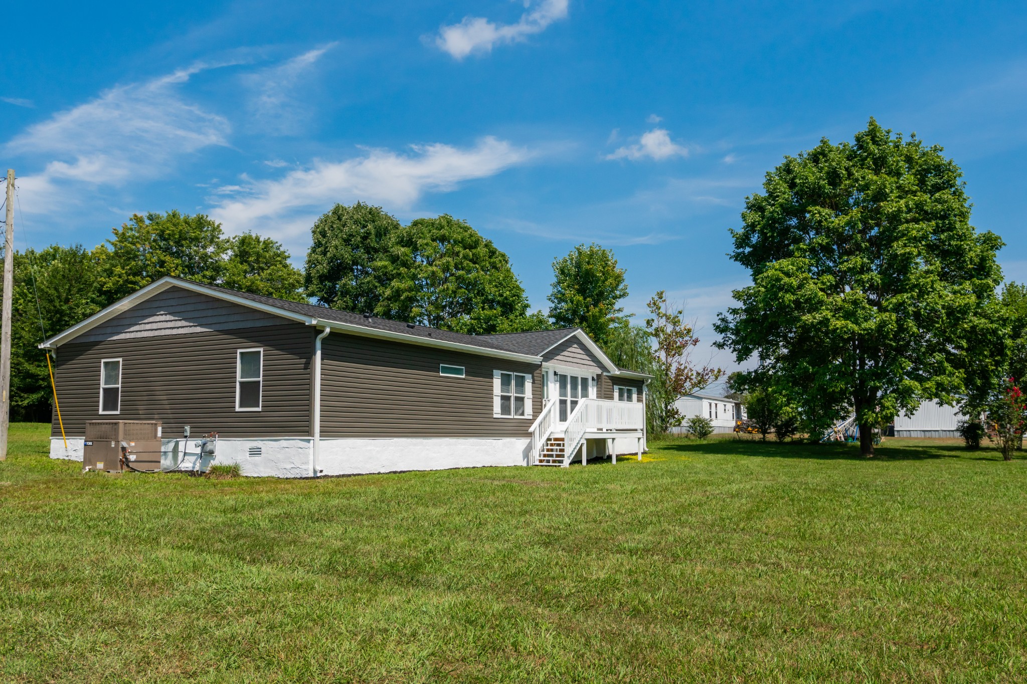 a front view of house with yard and green space