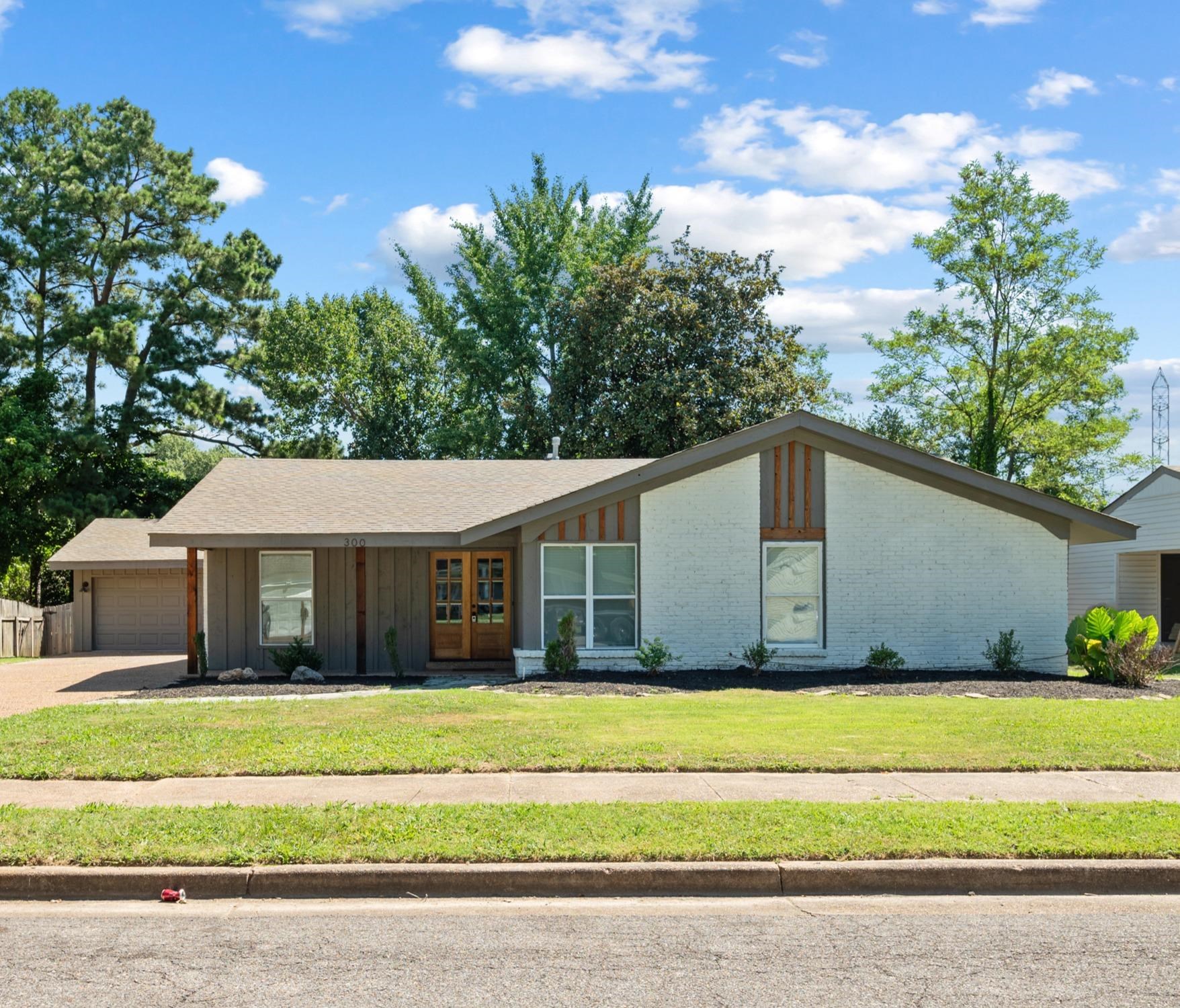 a front view of a house with a garden