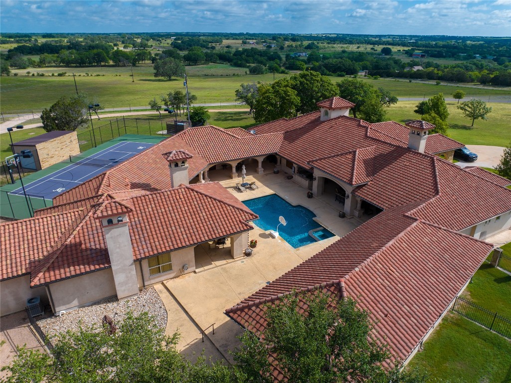 an aerial view of a house with a lake view and a floor to ceiling window