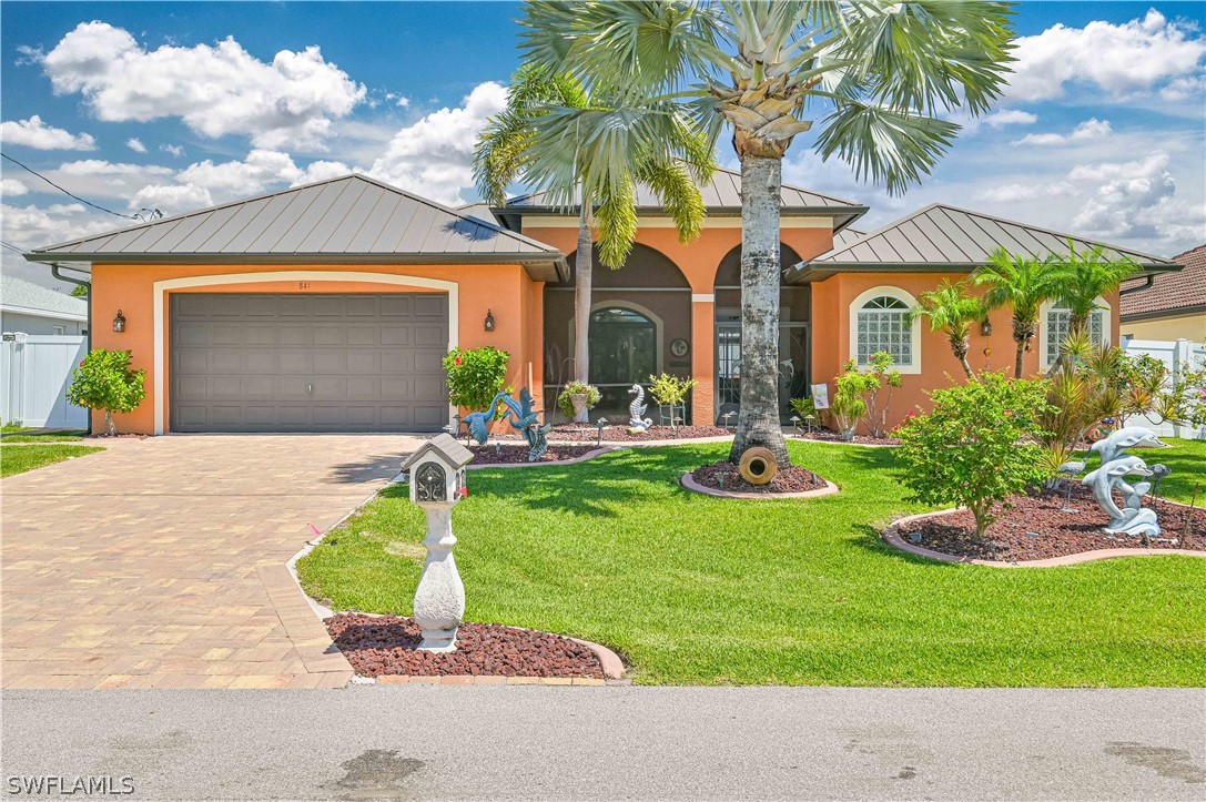 a front view of house with yard and outdoor seating