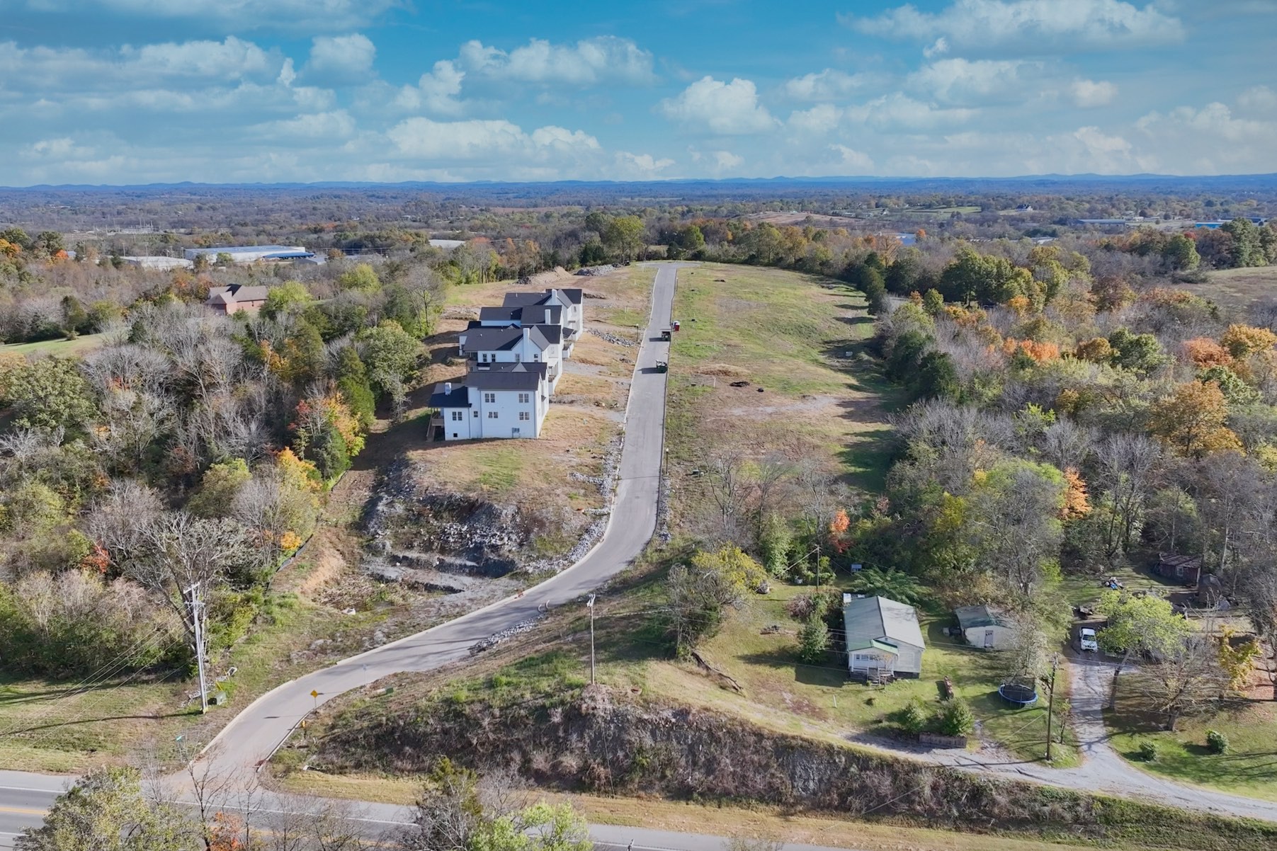 an aerial view of a house with a yard and lake view